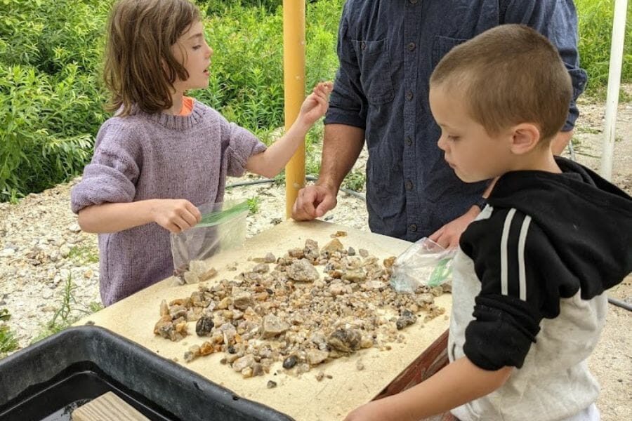 Two kids looking for various rock and mineral specimens