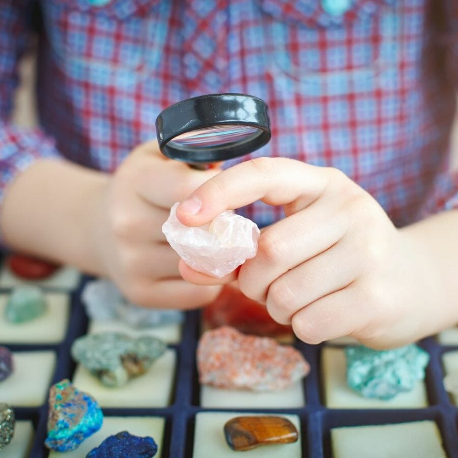 Examining the color of a crystal with a magnifying glass