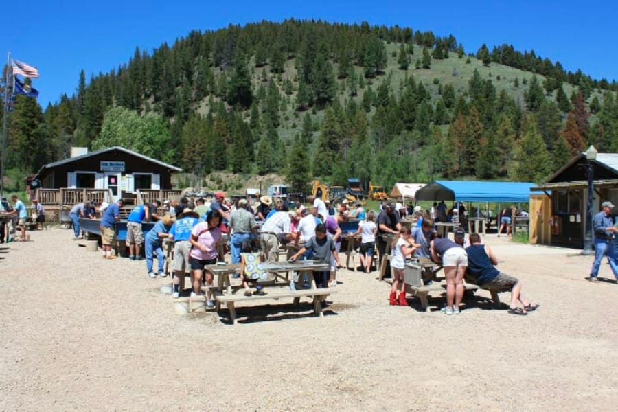 Families gather at the sluice and tables of Gem Mountain Sapphire Mine to sift for gems