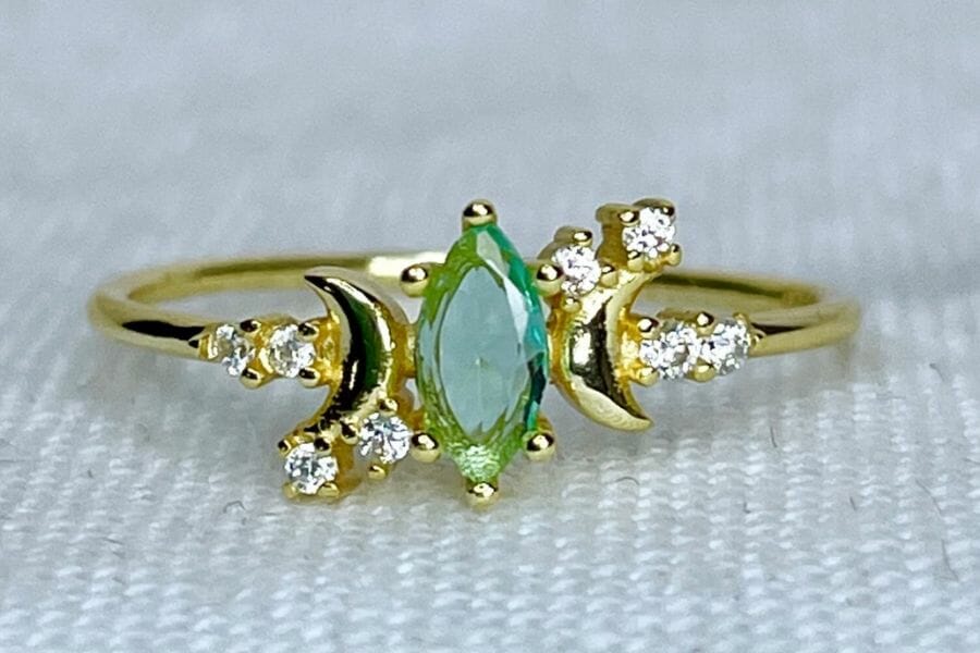 A gorgeous hiddenite gold ring with dainty stars and moon 