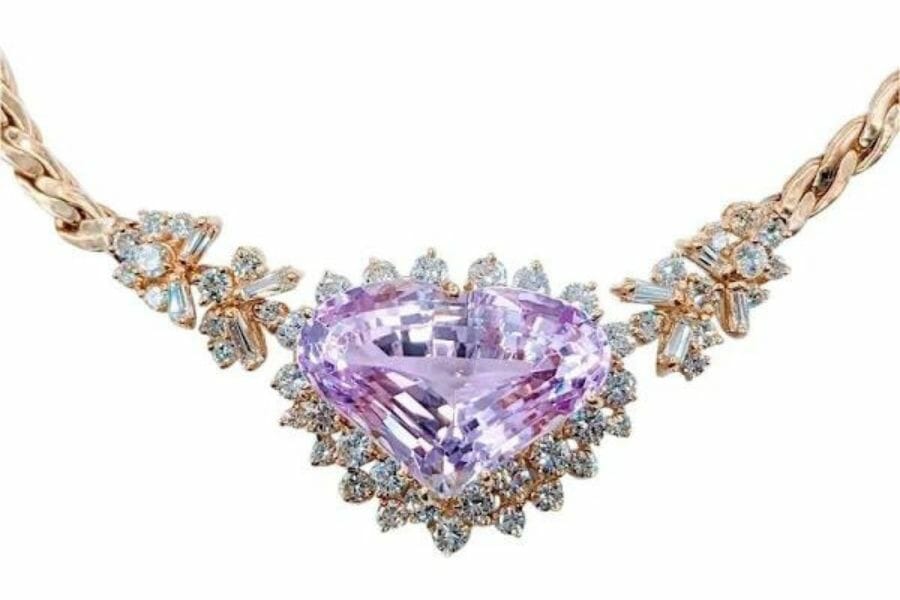 A sophisticated heart-shaped kunzite necklace studded with different cuts of diamond crystals and a rose gold chain 