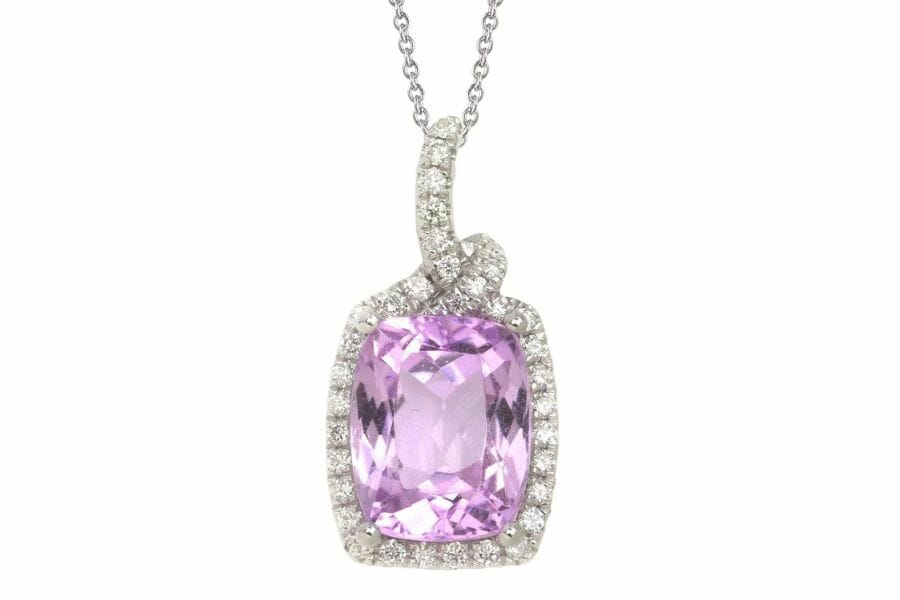 A radiant rectangular-shaped kunzite pendant with a diamond border and silver chain