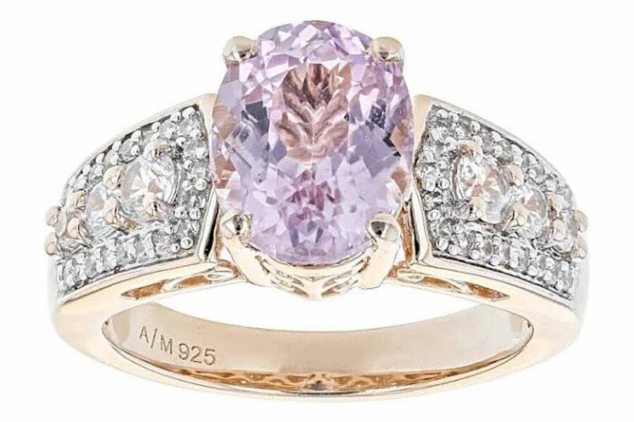 A big elegant kunzite crystal on a rose gold ring with diamond studs