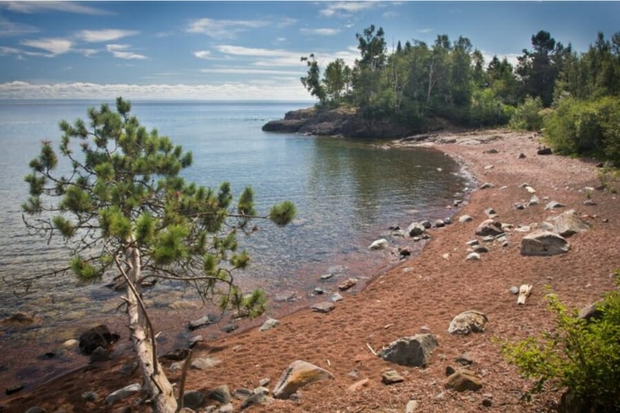 Brown sand and shores with big rocks of Lake Superior