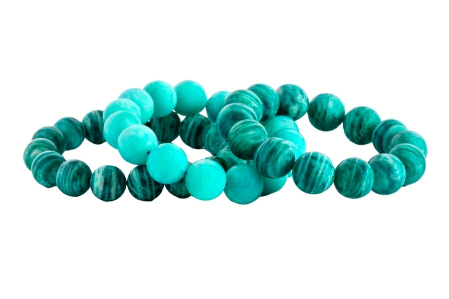 Three bracelets made of Microcline beads in vibrant and bright shades of blue green