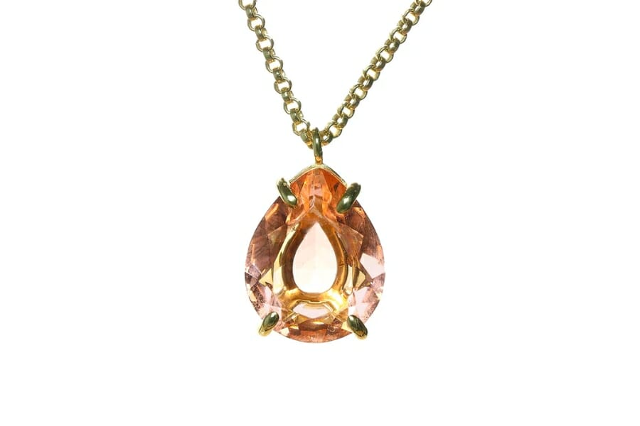 A stunning,shiny pinkish-blush Morganite pendant on a golden necklace