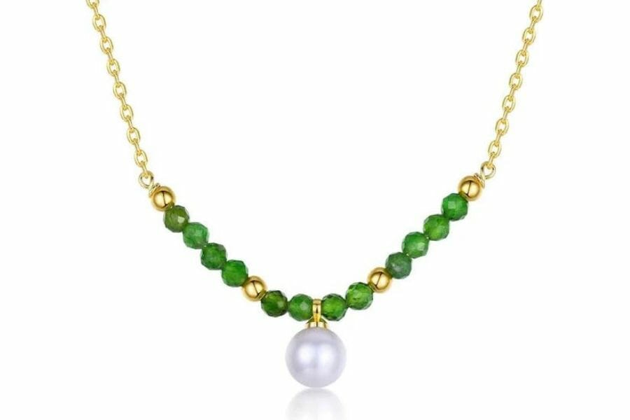 A beautiful gold necklace with olivine beads and a pretty pearl