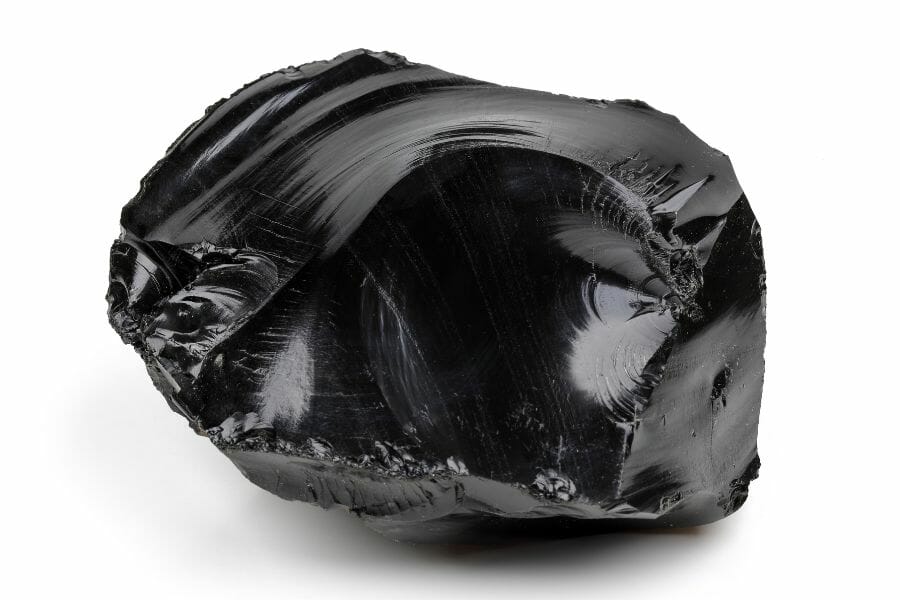 A beautiful obsidian tumbled stone with a smooth surface