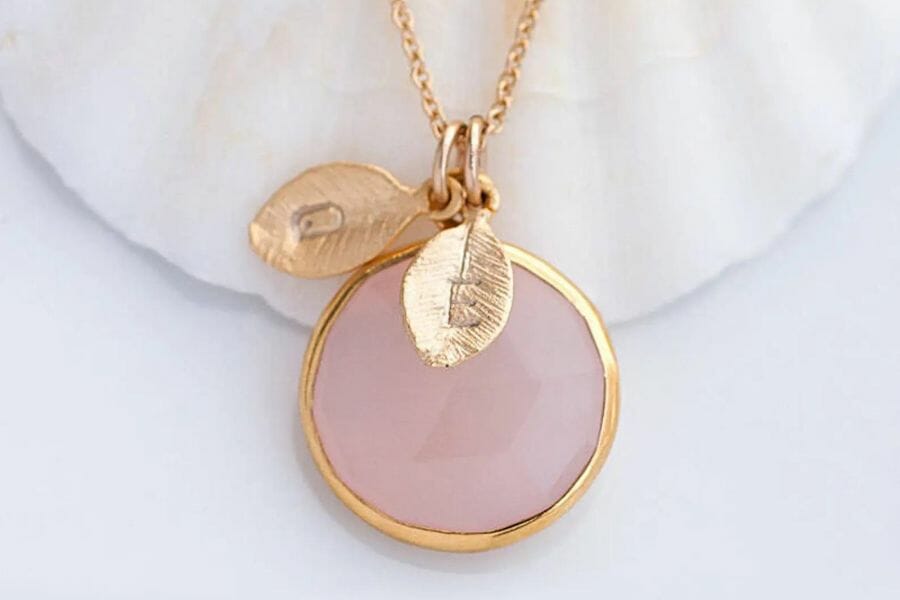 A pretty pink chalcedony pendant with leaf details and a rose gold detail