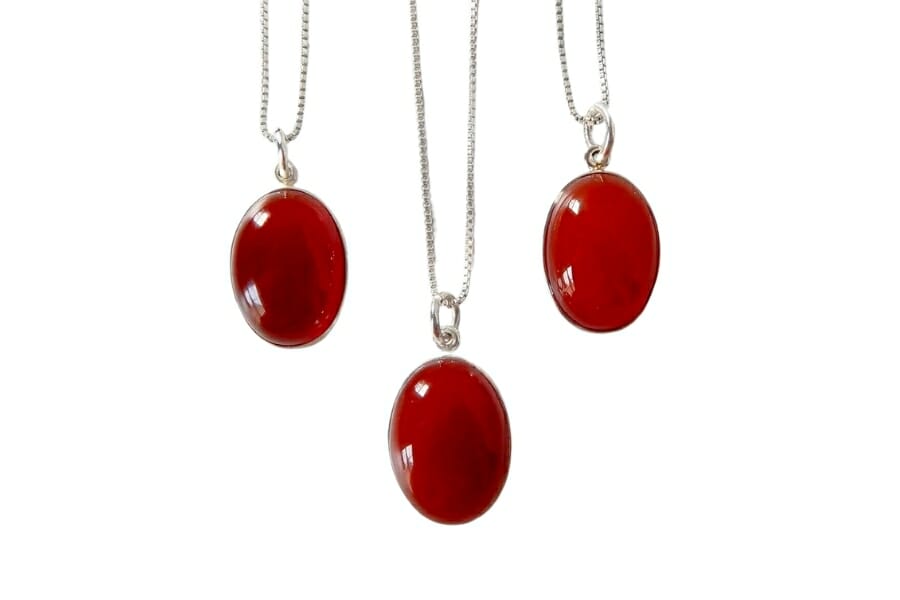 Three vibrant Red Carnelian set as pendants on silver necklaces