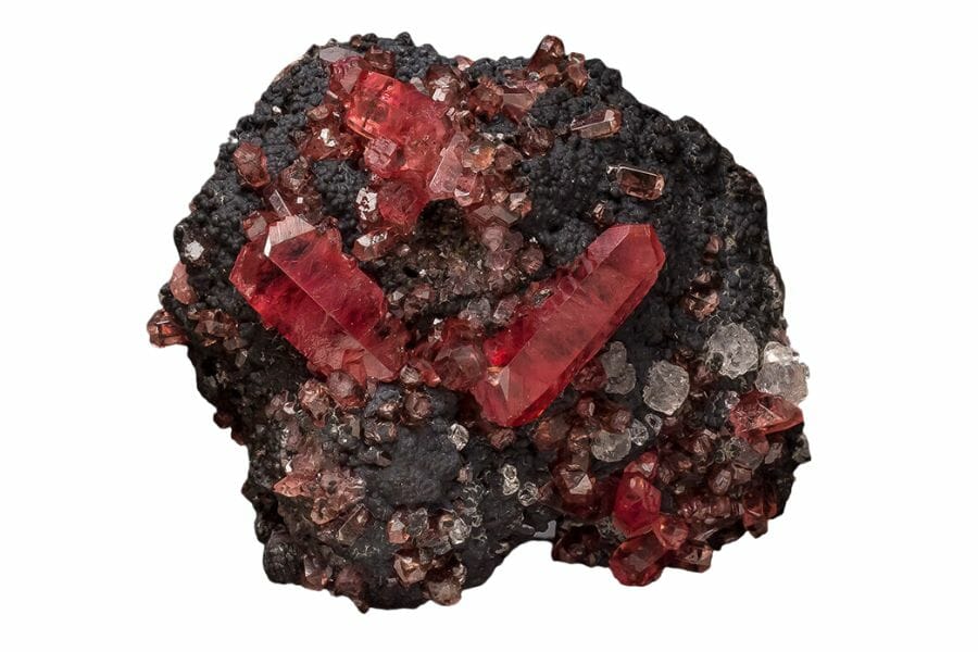 A mesmerizing rhodochrosite with black minerals around it