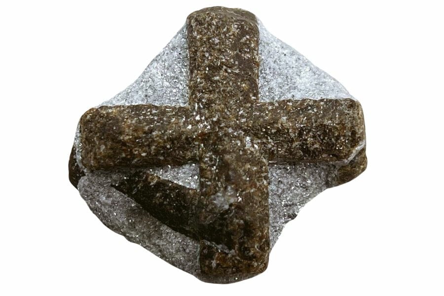 A gorgeous staurolite mineral with a rough surface and a unique and distinctive cross design