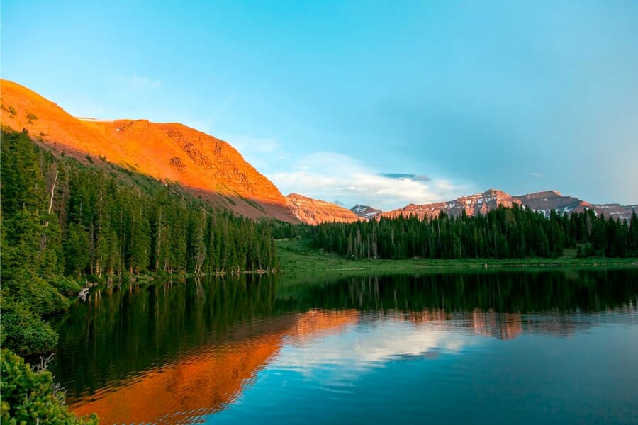 Stunning view of the peaks of Uinta Mountains foregrounded by a nearby waterway