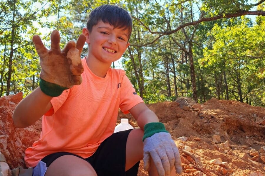 A young boy happily shows his find at Wegner Crystal Mines