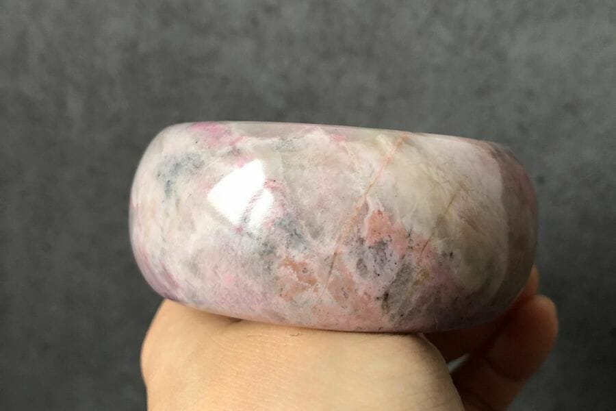 A pretty white rhodonite bangle with black and pink patches