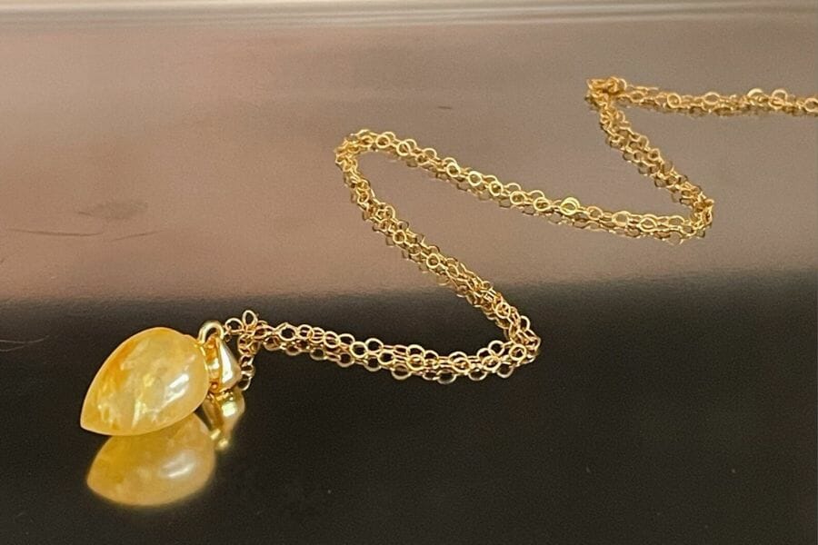 A brilliant yellow aventurine pendant necklace with a gold chain