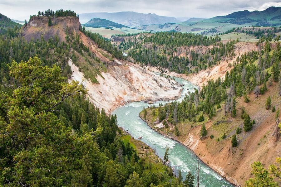 A wonderful aerial view of the Yellowstone River flowing in between mountains and hills