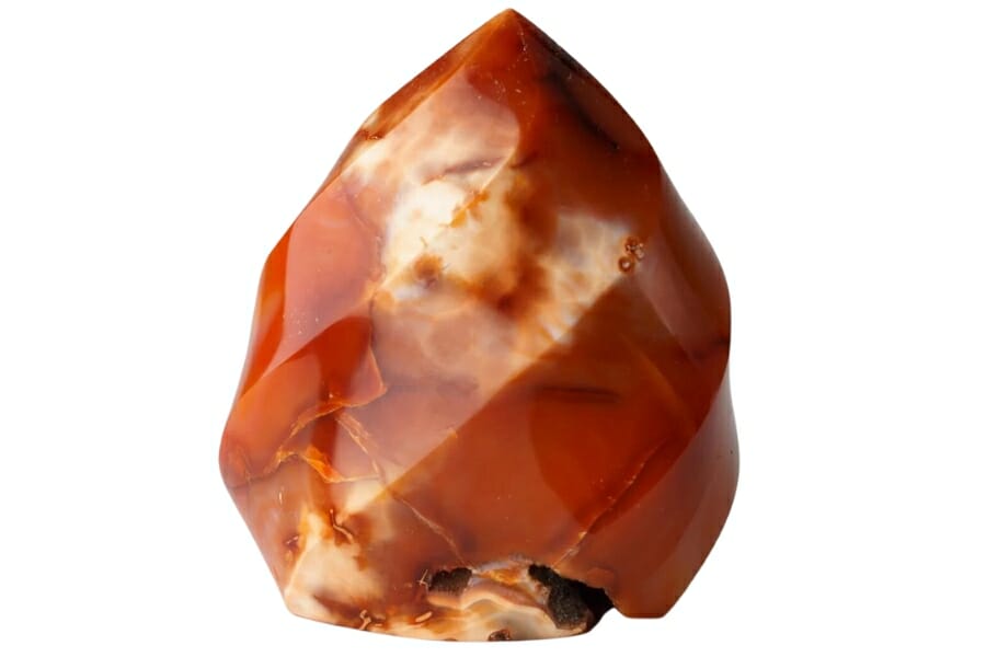A stunning pointy agate crystal with intricate details and different hues of red, orange, and white