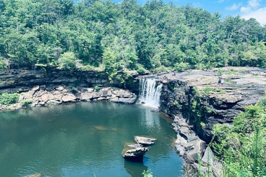 A waterfall flowing into a lake at Cedar Bluffs