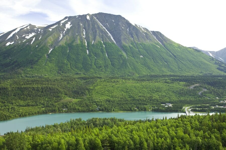 Stunning view of the surrounding towering mountains and thick forests at the Kenai River