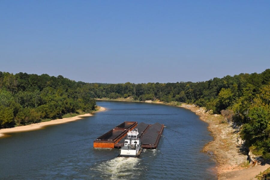 A big boat sailing through the stretch of Tombigbee River