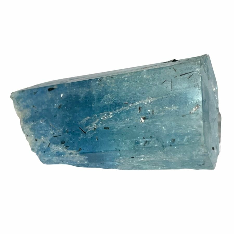 a piece of bright blue semi-opaque aquamarine crystal with black inclusions
