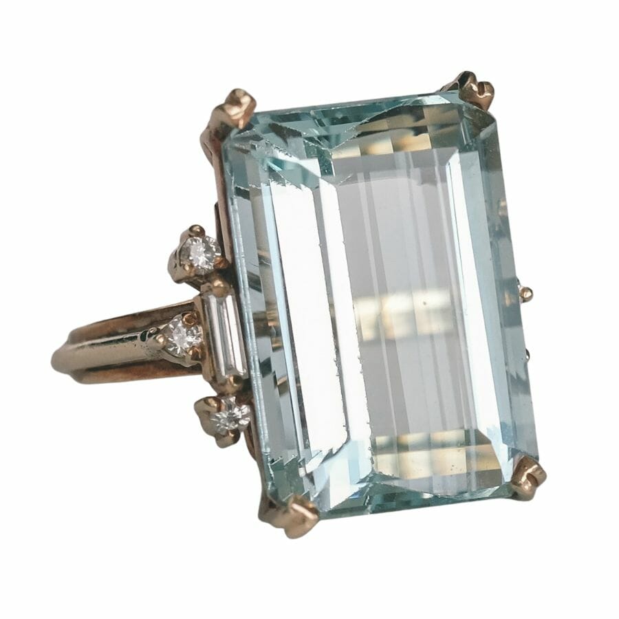 solitaire ring with translucent emerald-cut aquamarine