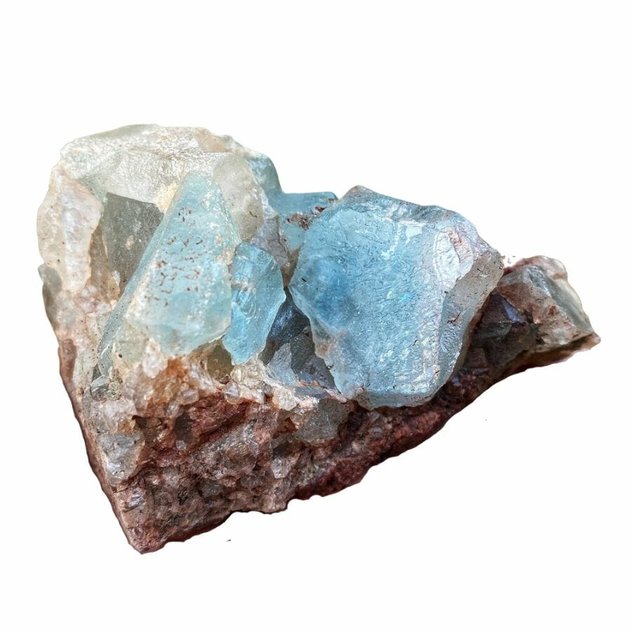 chunks of sky blue topaz crystals on a piece of rock
