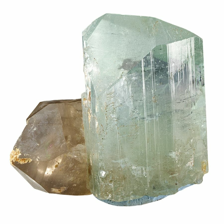 chunk of pale blue topaz with a piece of brown quartz behind it
