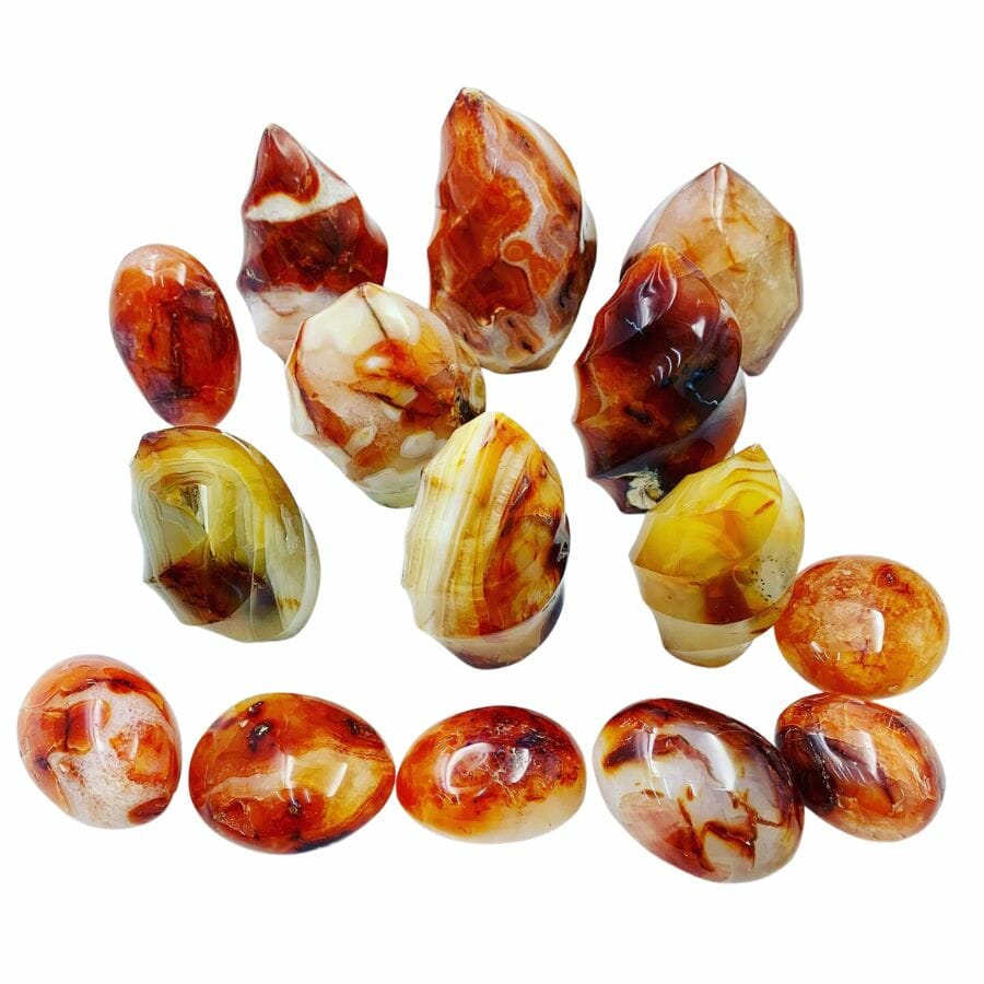 group of carnelian ornaments showing red, orange, yellow, black, brown, and white banding