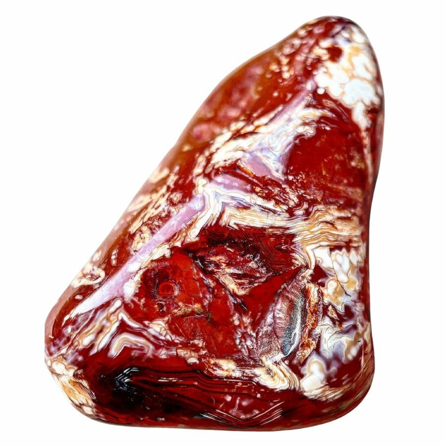tumbled bright red carnelian stone with white and brown banding