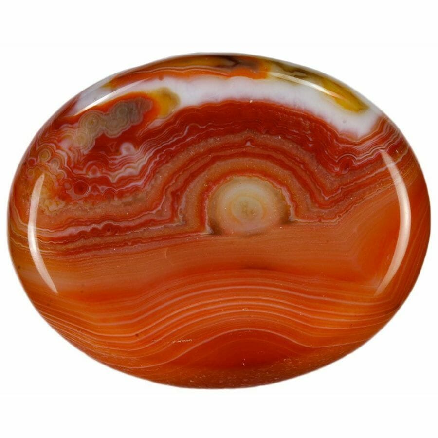 carnelian worry stone showing thin layers in red, white, brown, and orange