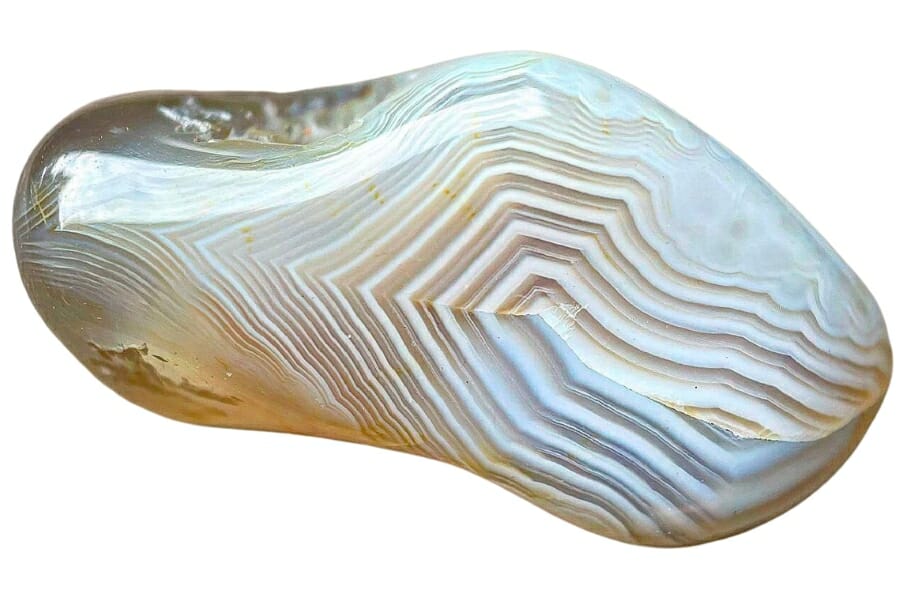 A shiny, polished piece of brownish agate showing white bands