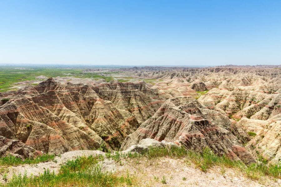 rock formations in the Badlands National Park showing red layers in the rock