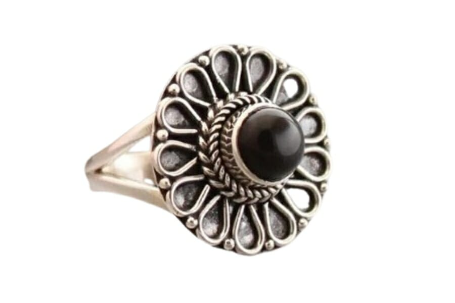 A tiny onyx cocktail ring with a beautiful flower petal designs