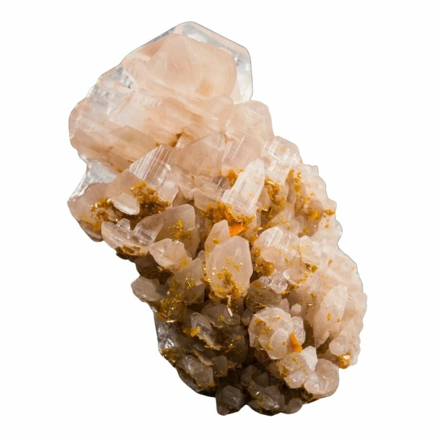 cluster of semi-translucent peach-colored cerussite crystals on a rock