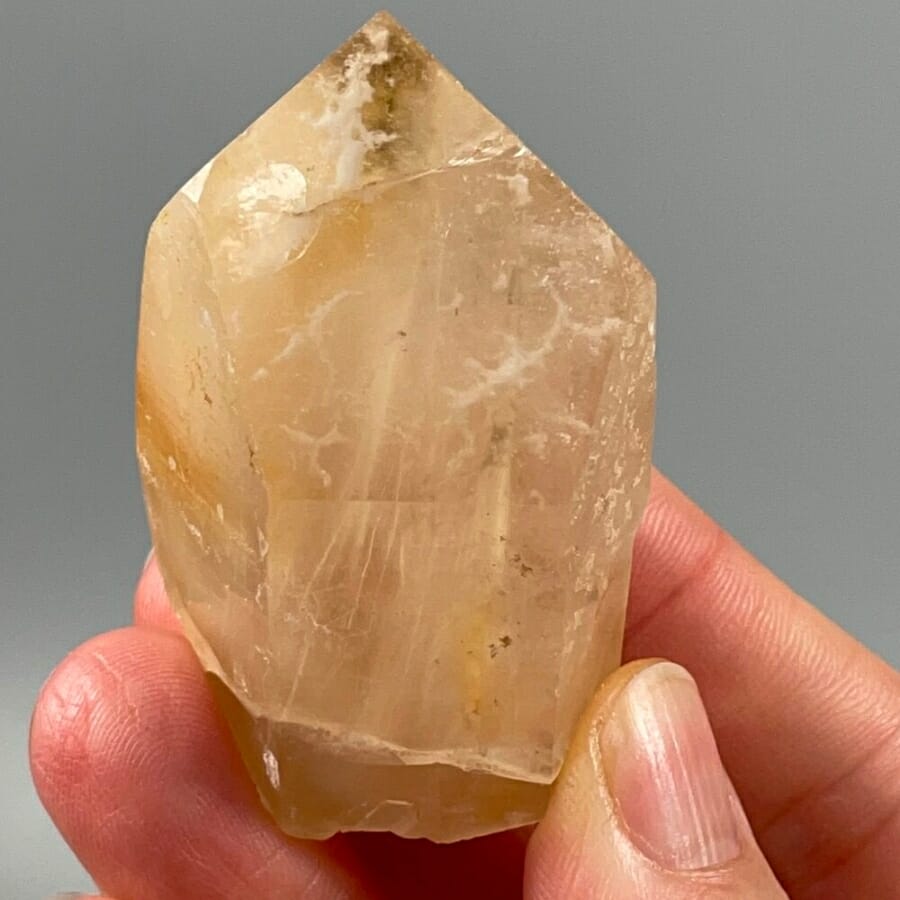 Holding a specimen up to check its crystal form and visible cleavage