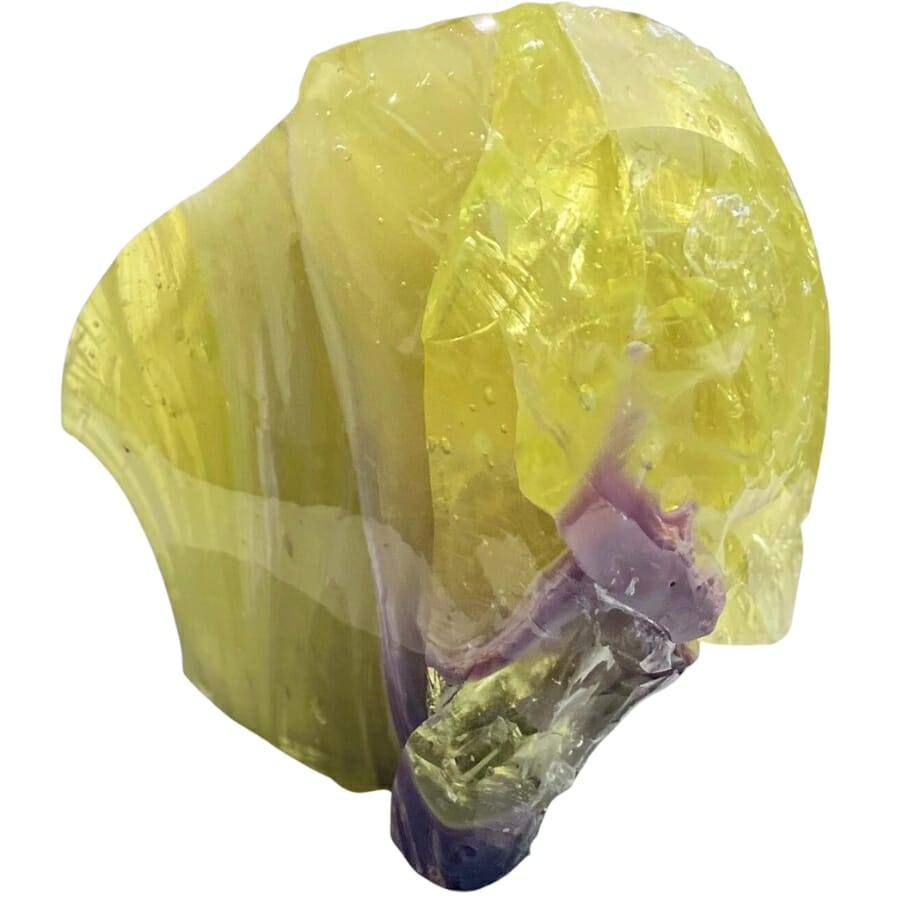 A brilliant cut yellow Andara crystal with a mysterious purple tint at the bottom