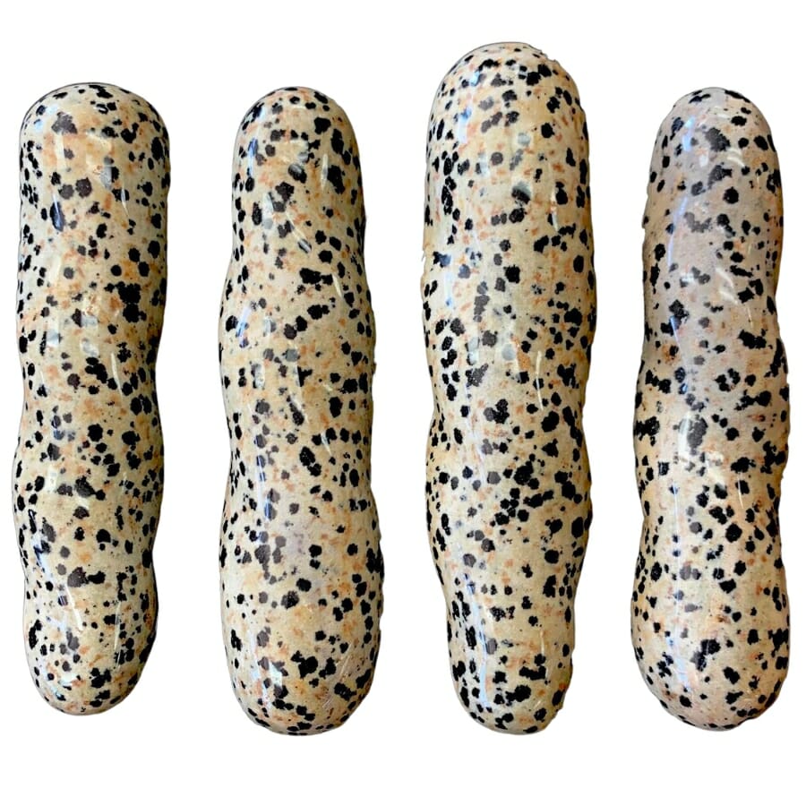 Four pieces of massage wands made out of Dalmatian stones