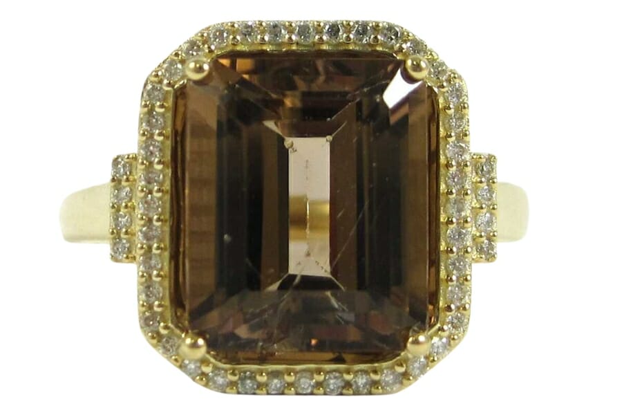 An elegant Dravite ring surrounded by stunning diamonds and golds
