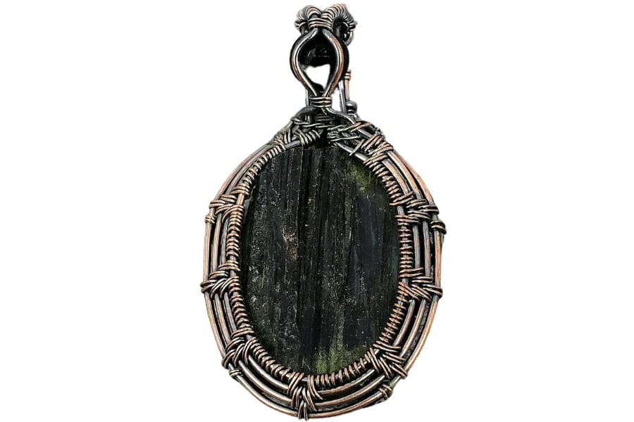 A gorgeous elbaite necklace pendant with intricate copper details around it