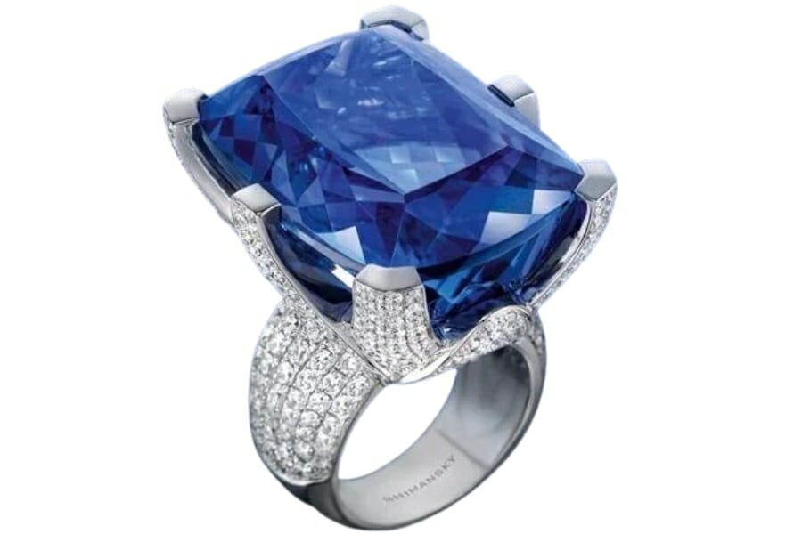 Expensive and elegant square cut tanzanite ring surrounded by tiny diamond crystals