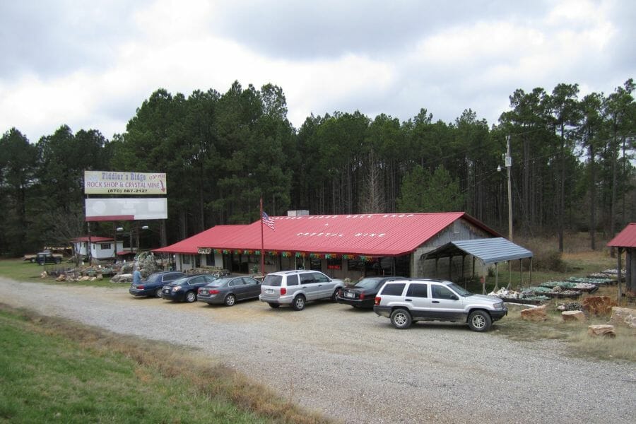 exterior of Fiddler's Ridge Rock Shop, a single-story building with a red roof and cars parked outside