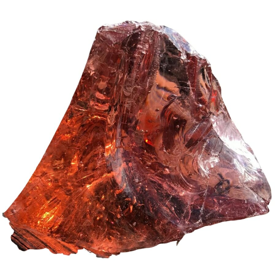 A fiery red Andara crystal with light reflecting on its surface