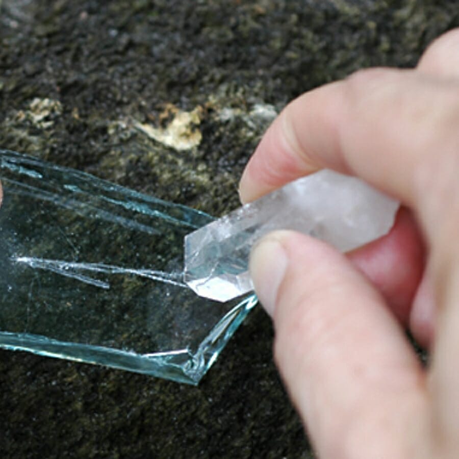 Scratching a mineral unto a glass