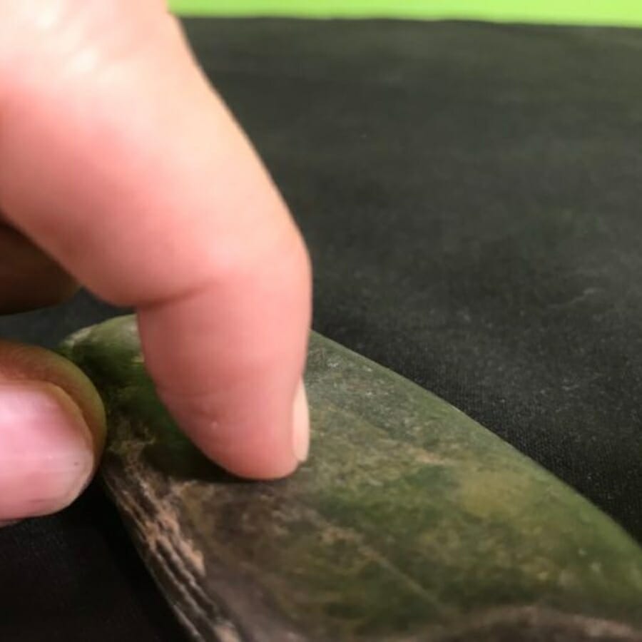 Testing a specimen's hardness against a fingernail