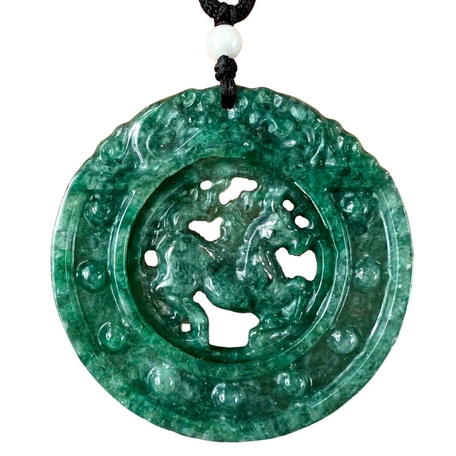 A round, carved deep green Jade pendant