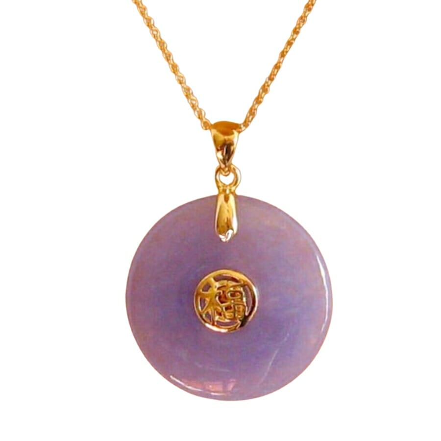 Purple jade pendant on a gold necklace