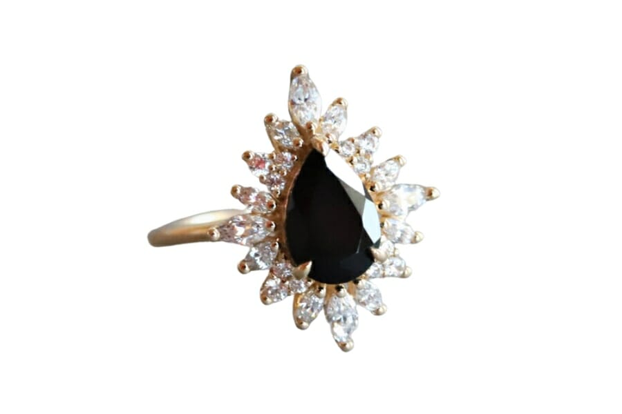 A stunning black onyx per-shaped ring surrounded by diamond crystals
