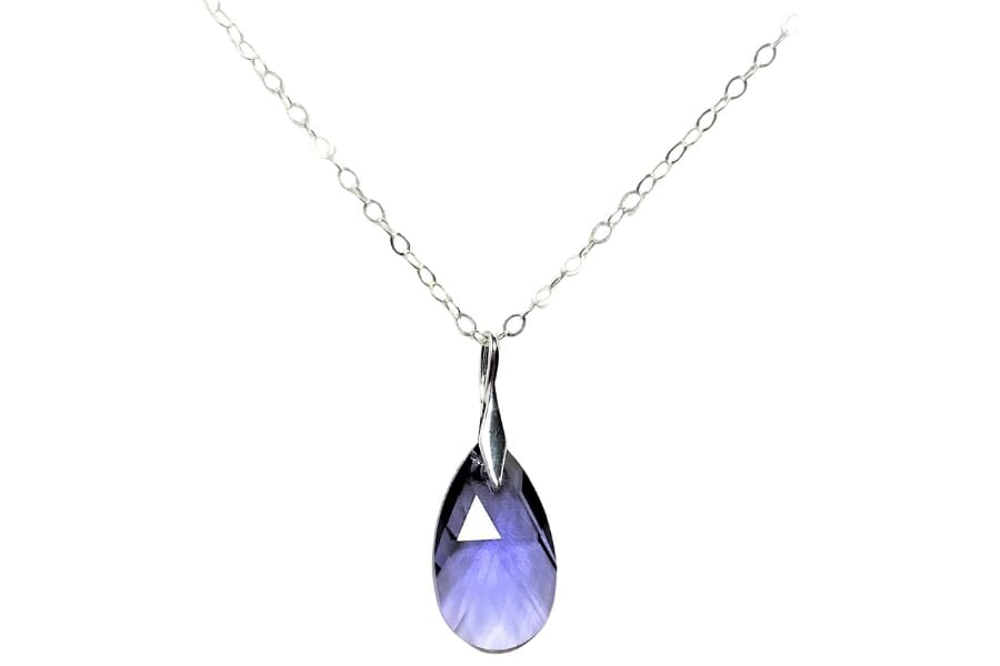 A brilliant purple tanzanite teardrop pendant on a silver chain